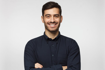 Fototapeta Handsome smiling business man in blue shirt isolated on gray background obraz