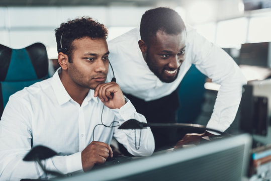 Two operators looking on dispatch board screen