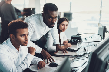 Dispatch specialist consulting his colleagues by work