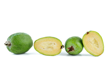 Whole and sliced feijoa fruits isolated on white background