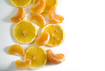 sliced citrus fruits laid out on the background