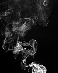 Fototapeta premium Smoke catching the light against a black background