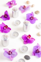 Obraz na płótnie Canvas Burning candles and orchid flowers on wooden background. Relaxation spa concept