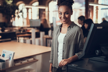 Beautiful afro american girl standing near office equipment