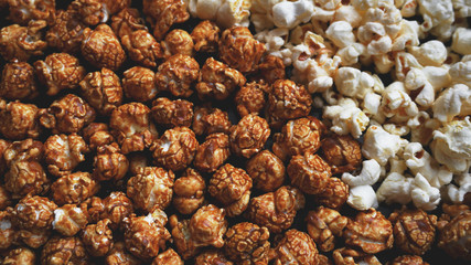 Assorted popcorn set. Sweet and salty popcorn on black background
