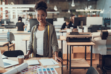 Charming afro american lady in glasses working at modern office