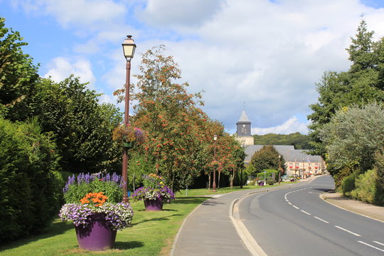 the road in vittefleur with flower boxes in the verge in summer