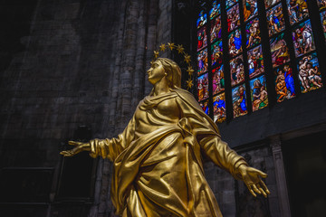 Milan, Italy - AUGUSTA 18, 2018: Interior of Milan Cathedral Duomo. Statue of golden Madonna