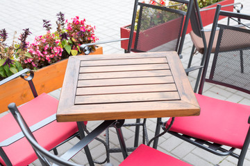 View of an empty table in the garden of cafe.