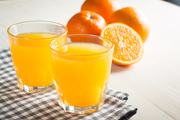 Photo of fresh orange juice in the glass jar. Summer healthy organic drink concept. Cold beverages with ice and orange fruits.