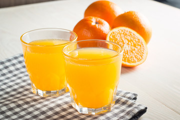 Photo of fresh orange juice in the glass jar. Summer healthy organic drink concept. Cold beverages with ice and orange fruits.