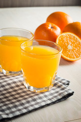 Photo of fresh orange juice in the glass jar. Summer healthy organic drink concept. Cold beverages with ice and orange fruits.