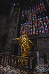 Milan, Italy - AUGUSTA 18, 2018: Interior of Milan Cathedral Duomo. Statue of golden Madonna