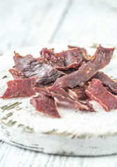 Beef jerky on the white wooden board