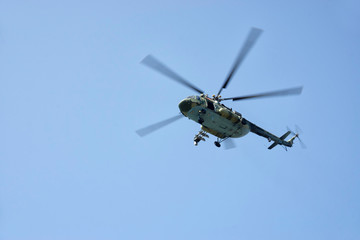 Combat helicopter in blue sky