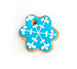 Cookie in a shape of blue snowflake, isolated on white. Christmas holiday decoration, winter time food.