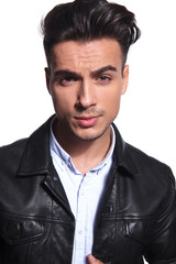 portrait of attractive smart casual man in leather jacket