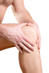 Fototapeta na wymiar A man touches a sore knee on a white background.