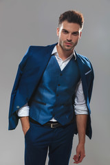 potrait of relaxed man wearing blue waistcoat and suit
