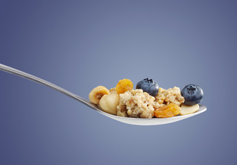 Spoon with cereal and fruits