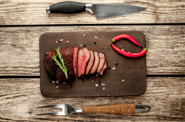 beef steak on a cutting board. on wooden background