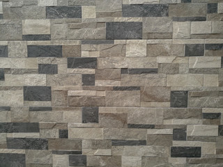 Grey brick stone wall texture or background material of industry construction, rough surface.