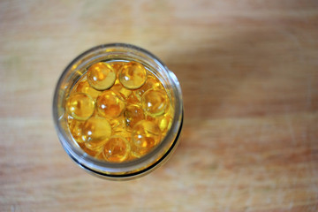 Yellow capsules in a jar