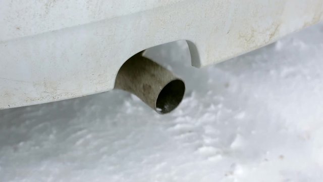 air pollution exhaust gases, the car starts in the winter, the exhaust pipe close-up