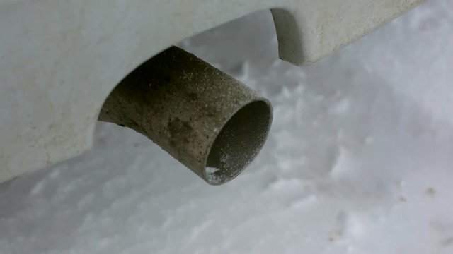 air pollution exhaust gases, the car starts in the winter, the exhaust pipe close-up