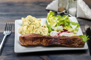 Beef steak with mashed potatoes and rocket salad