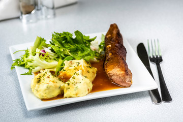 Beef steak with mashed potatoes and rocket salad