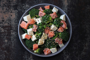 Poke bowl with salmon and broccoli.