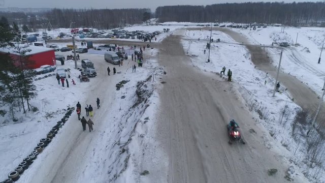 Russia, Championship on snowmobiles January 27, 2018: Winter racing on snowmobiles. Aerial view: Snowmobile on the route in a jump. Action from snowmobile races.