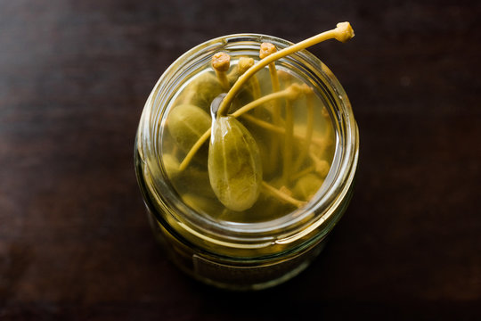 Jar of Capers in Water Pickled and Canned Ready to Eat in Glass Bowl.