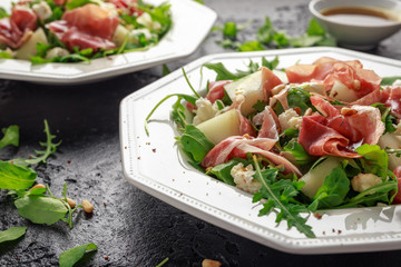 Parma ham and melon salad with mozzarella, rocket and pine nuts