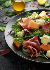 Parma ham and melon salad with mozzarella, green leaves mix