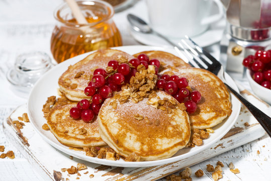 delicious pancakes with berries and honey for breakfast