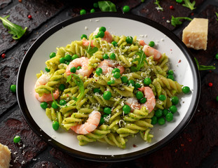 Italian pasta in a creamy pesto sauce with shrimp, prawns