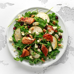 Pear, chicken salad with blue cheese, cranberry and walnuts. concept healthy food