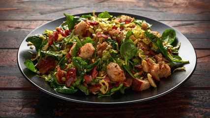 Roasted brussel sprouts, bacon warm salad with spinach, croutons and hazelnuts