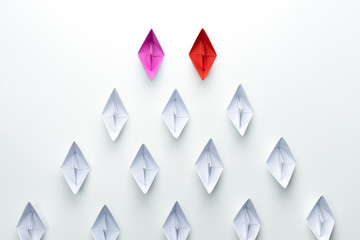 Red and pink paper ship leading among white. Equality or Competition for leadership between men and...