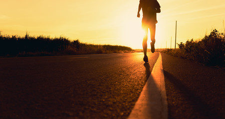 Athlete runner feet running on road