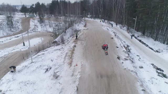 Russia, Championship on snowmobiles January 27, 2018: Winter racing on snowmobiles. Aerial view: Snowmobile on the route in a jump. Action from snowmobile races.