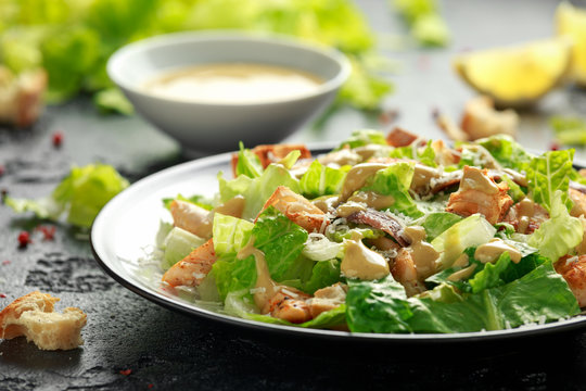 Caesar salad with chicken, anchous fish, croutons, parmesan cheese and greens. healthy food