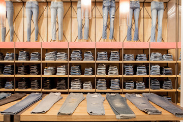 Jeans pants on the store shelf. Blue jeans denim Collection jeans stacked