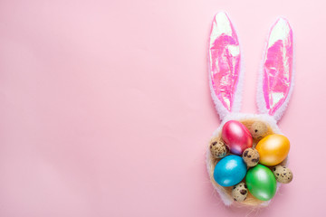 Easter holiday background.Easter egg with ears on a pink background, horizontal composition. Greeting card concept