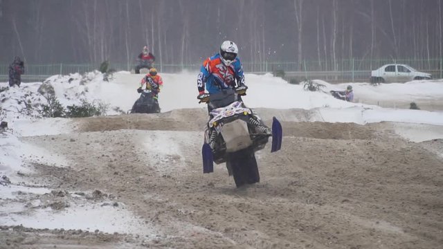 Russia, Championship on snowmobiles January 27, 2018: Winter racing on snowmobiles. Snowmobile on the route in a jump. Action from snowmobile races.