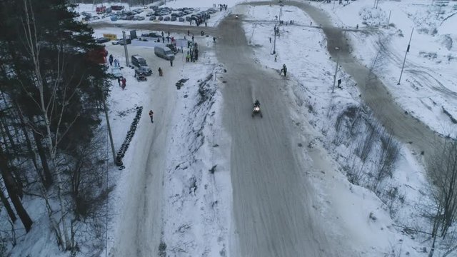 Russia, Championship on snowmobiles January 27, 2018: Winter racing on snowmobiles. Aerial view: Snowmobile on the route in a jump. Action from snowmobile races.