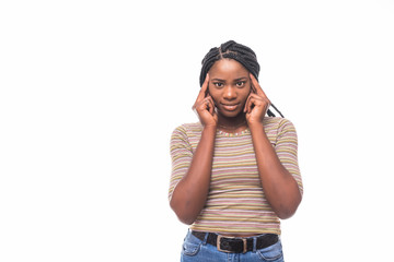 Attractive young girl in casual t-shirt keeping hand on chin in doubt and suspicion, feeling sceptical about something