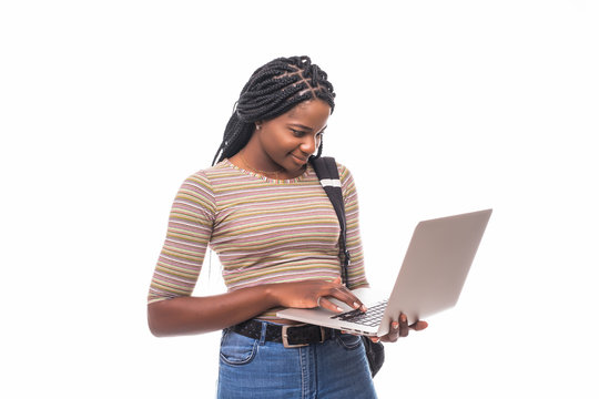 African Pretty Woman High School Student Typing On Portable Computer Isolated On White Background